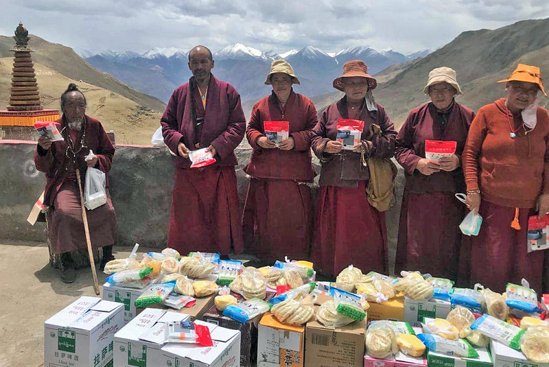 Monks and nuns receiving supplies and lights and supplies